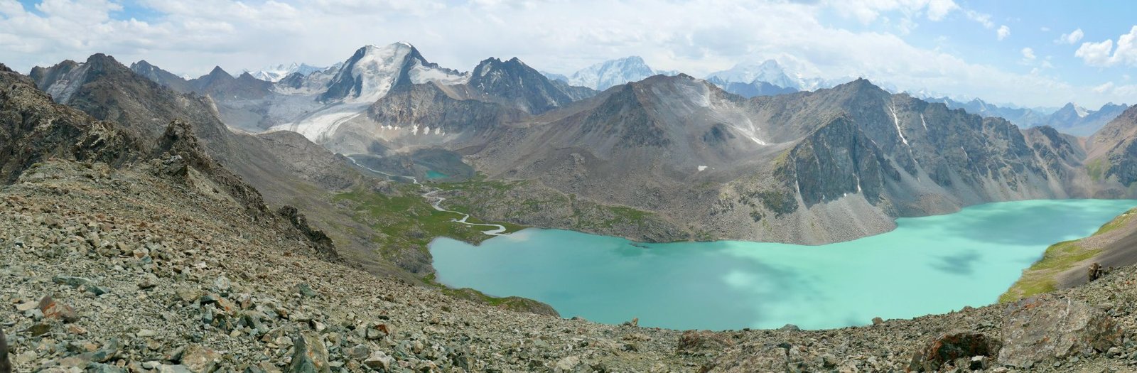 The turquoise water of Ala-Kul lake on the trek above Karakol, Kyrgyzstan