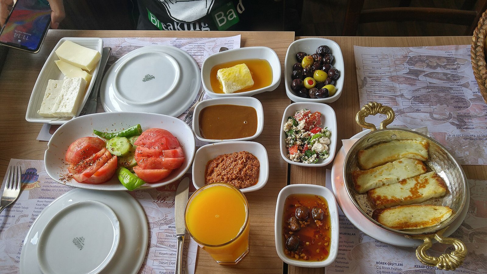 A Turkish breakfast spread with cheeses, olives, tomatoes, jams and bread